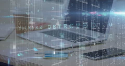 Cyber Attack Warning Overlaying Laptop Screen