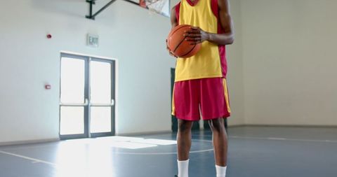 Basketball Player Preparing for Game in Indoor Court