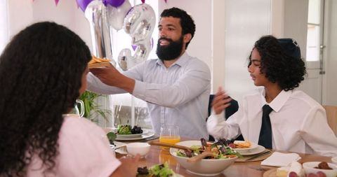 Family celebrating together at dinner table during festive gathering