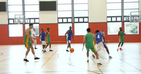Basketball Game in Gym Highlighting Intense Teamwork and Strategy