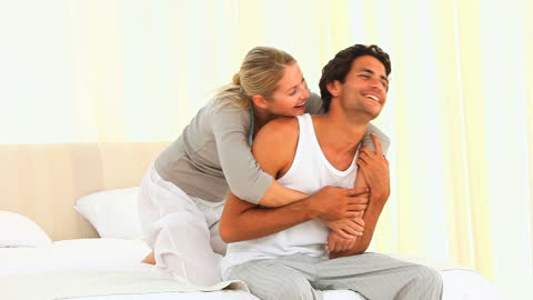 Happy Couple Laughs During Playful Morning