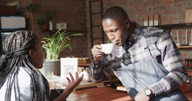 Barista Enjoying Coffee Break While Conversing with Colleague - Download Free Stock Images Pikwizard.com