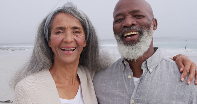 Happy Senior Couple Smiling at Beach on Cloudy Day - Download Free Stock Images Pikwizard.com