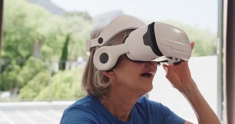 Senior Woman Exploring Virtual Reality Technology at Home