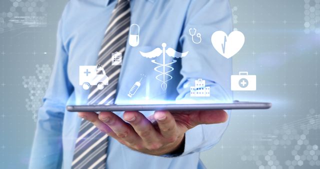 Businessman Presenting Digital Healthcare Icons on Tablet - Download Free Stock Images Pikwizard.com