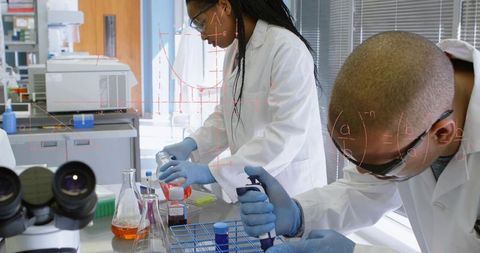 Researchers pipetting reagents at benchtop, conducting lab experiments and collaboration