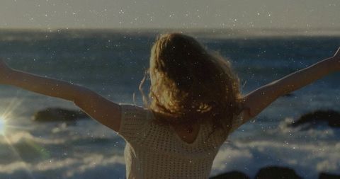 Woman Embracing Nature at Scenic Coastal View