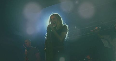 Dynamic Female Lead Singer Energizing Concert Stage