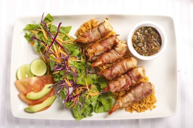Grilled Bacon-Wrapped Shrimp Served with Fresh Salad - Download Free Stock Photos Pikwizard.com