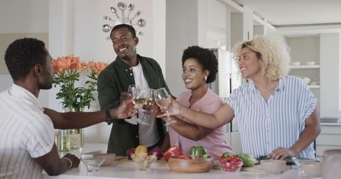 Friends Cooking and Toasting in a Modern Kitchen
