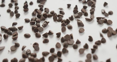 Scattered Chocolate Chips on White Surface - Download Free Stock Images Pikwizard.com