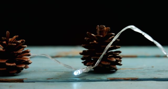 Pine Cones Decorated with String Lights on Wooden Table - Download Free Stock Images Pikwizard.com