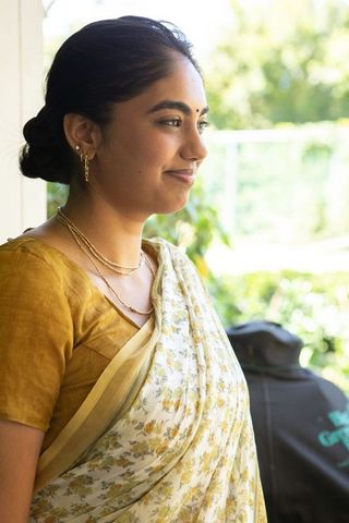 Elegant indian woman in floral sari on veranda