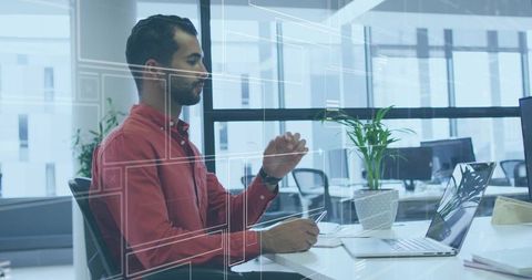 Professional Man Using Stylus to Navigate Digital Interface at Office