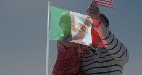 Father holding daughter raising us flag with mexican flag overlay showing bicultural pride