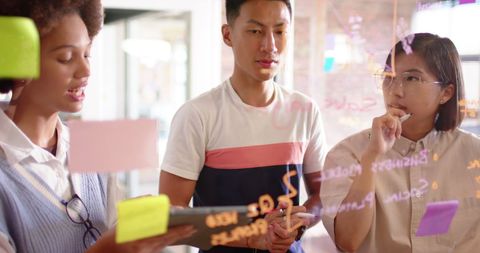 Diverse Colleagues Brainstorming Creativity at Office Glass Wall