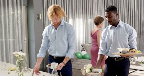 Friends Cleaning Mess After Indoor Wedding Party Celebration