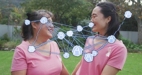 Asian Women Embracing Friendship with Digital Connections