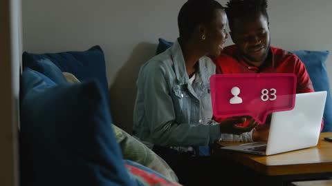 Couple Engaging with Social Media on Laptop at Home