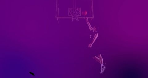 Dynamic Basketball Player Dunking in Stadium with Purple Overlay