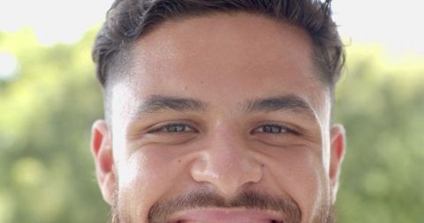 Cheerful Young Man Enjoying Nature's Summer Sunlight