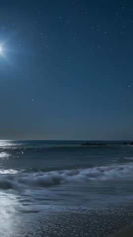 Full Moon Shining over Ocean Waves Pulling Tide and Breaking on Sandy Shore at Night
