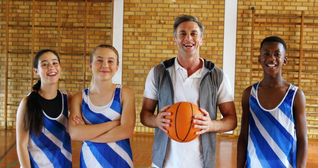 Coach with Multiracial Basketball Team Smiling at Camera in Indoor Gym - Download Free Stock Images Pikwizard.com