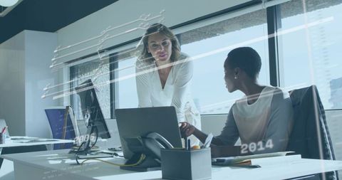 Two Colleagues Collaborating at Laptop in Bright Minimalist Office with City Skyline