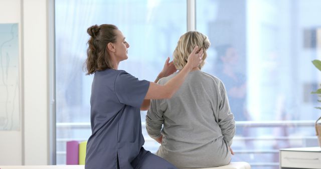 Physical Therapist Assessing Female Patient's Upper Back - Download Free Stock Images Pikwizard.com