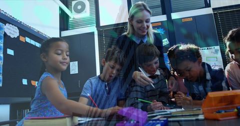 Teacher assisting diverse students using digital resources