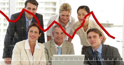 Business team analyzing declining performance on red line graph during strategy meeting