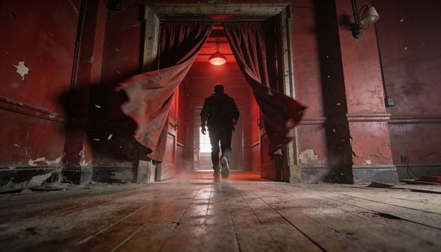 Tactical silhouette walking through abandoned crimson corridor cinematic thriller scene