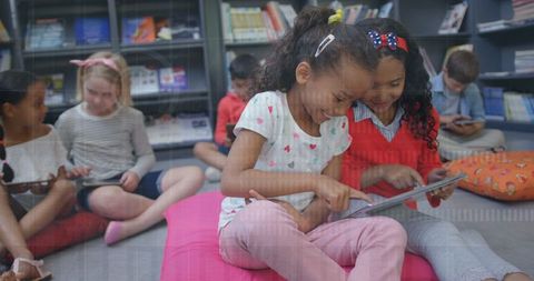 Multiracial Students Exploring Tablets with Futuristic Touch Interface