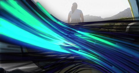 Woman observing hills with dynamic colorful flows