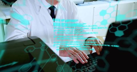 Senior scientist typing on laptop with holographic code and hexagonal data overlay