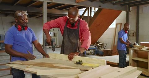 Team of Diverse Craftsmen Working on Wood Projects in Workshop