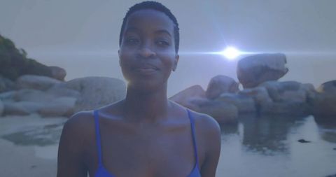 Tranquil moment by rocky shore with blue swimsuit