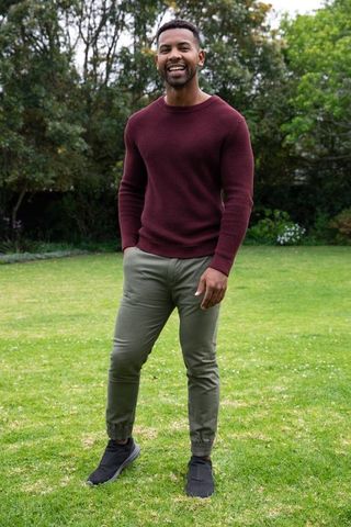 Smiling man enjoying sunny day outdoors in casual attire