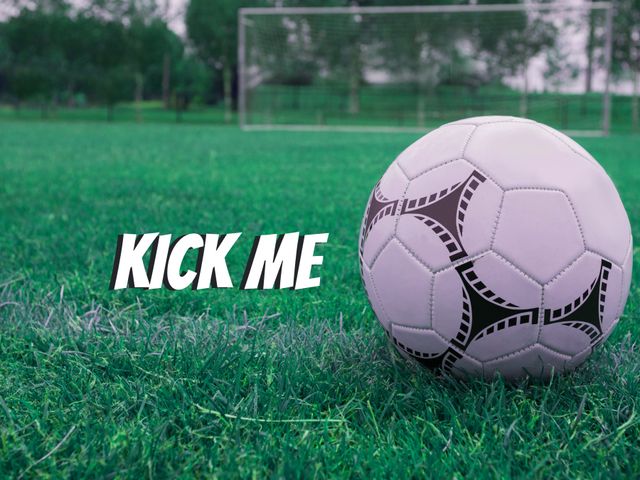 Soccer Ball with 'Kick Me' Text on Green Grass Field - Download Free Stock Templates Pikwizard.com