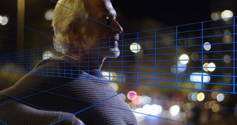 Senior man gazing over city night with blue wireframe grid suggesting future technology