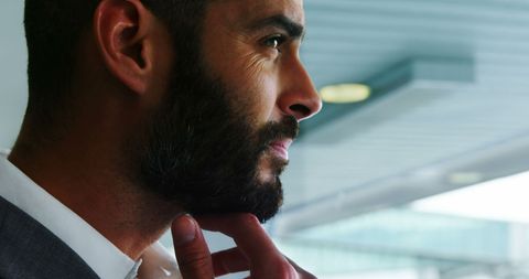 Businessman waiting thoughtfully in airport terminal