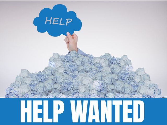 Image depicts a hand reaching out from a large pile of papers while holding a help sign, signifying a call for help in job-related stress or the need for assistance. Ideal for use in posters, job advertisements, stress management brochures, and articles about workplace stress.