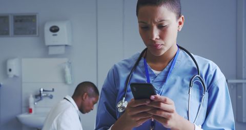 Doctor Checking Smartphone in Hospital Office - Download Free Stock Images Pikwizard.com