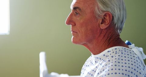 Worried Senior Patient Contemplating Healthcare in Hospital Room