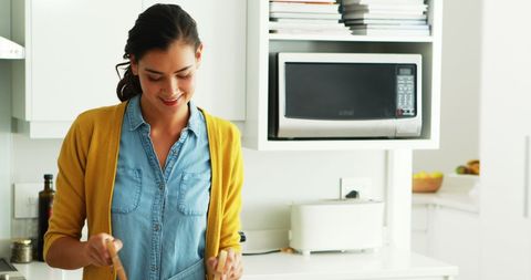 Woman Cooking in Modern Kitchen with Fresh Ingredients