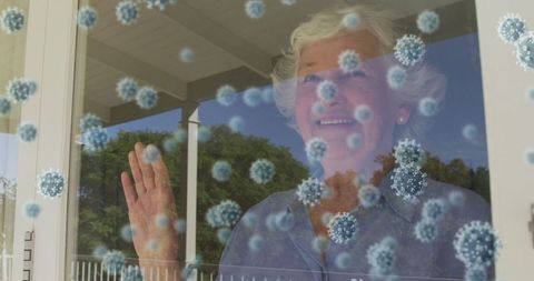Senior Woman Smiling Behind Window with Floating Virus Cells