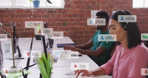 Young professionals collaborating in brick open-plan office with headsets and notifications