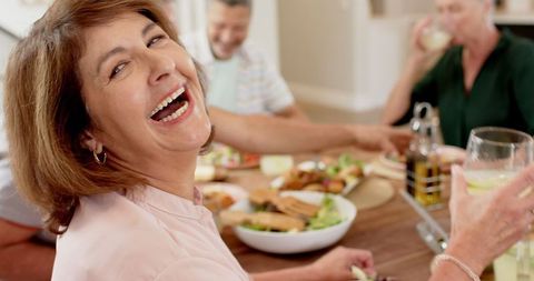 Joyful multi-generational family meal gathering unexpected fun