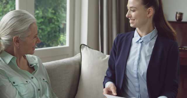 Smiling Caregiver Assisting Elderly Woman at Home - Download Free Stock Images Pikwizard.com