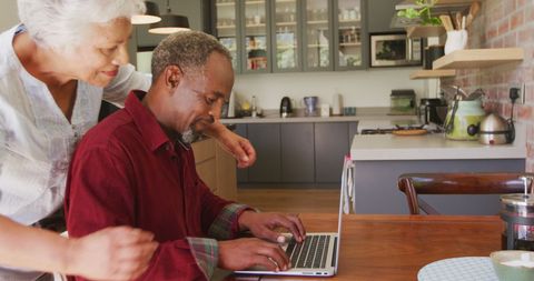 Senior Couple Enjoying Time Together on Laptop in Kitchen - Download Free Stock Images Pikwizard.com